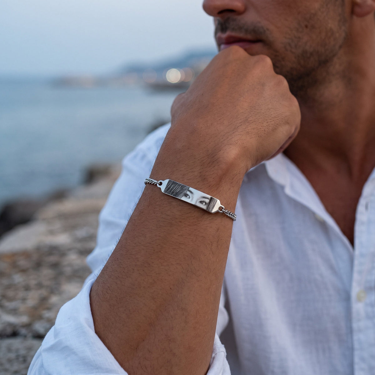 Man wearing the silver eye bracelet with photo engraving